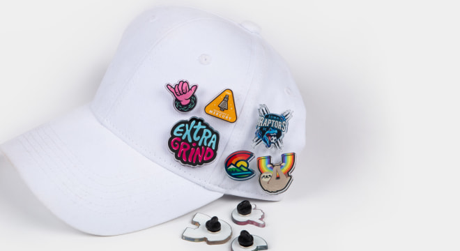 Custom hat pins on a white cap