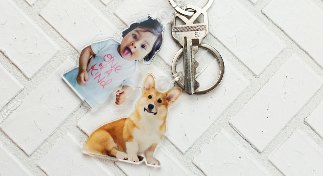 Two personalized keychains with a picture of a child and a dog
