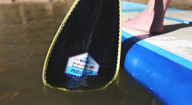Custom weatherproof stickers applied to paddleboard