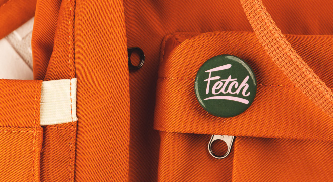 custom 1.25 button on orange canvas bag