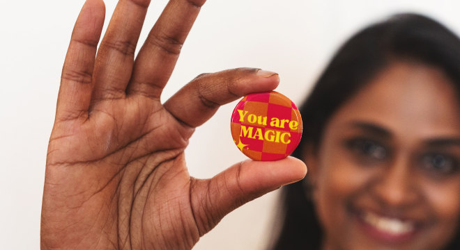 holding up a you are magic custom button