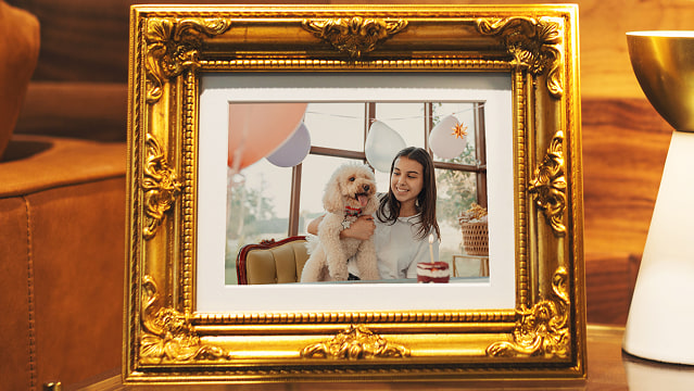 Framed photo in gold frame on table