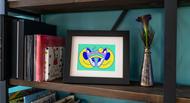 Framed illustration in gold frame on shelf