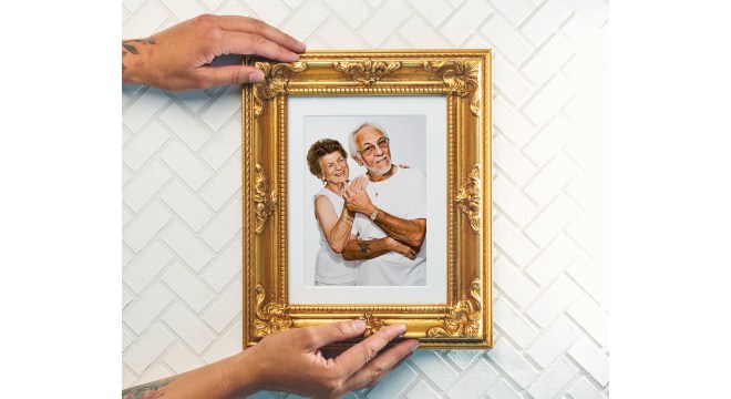 Framed photo in gold frame on wall