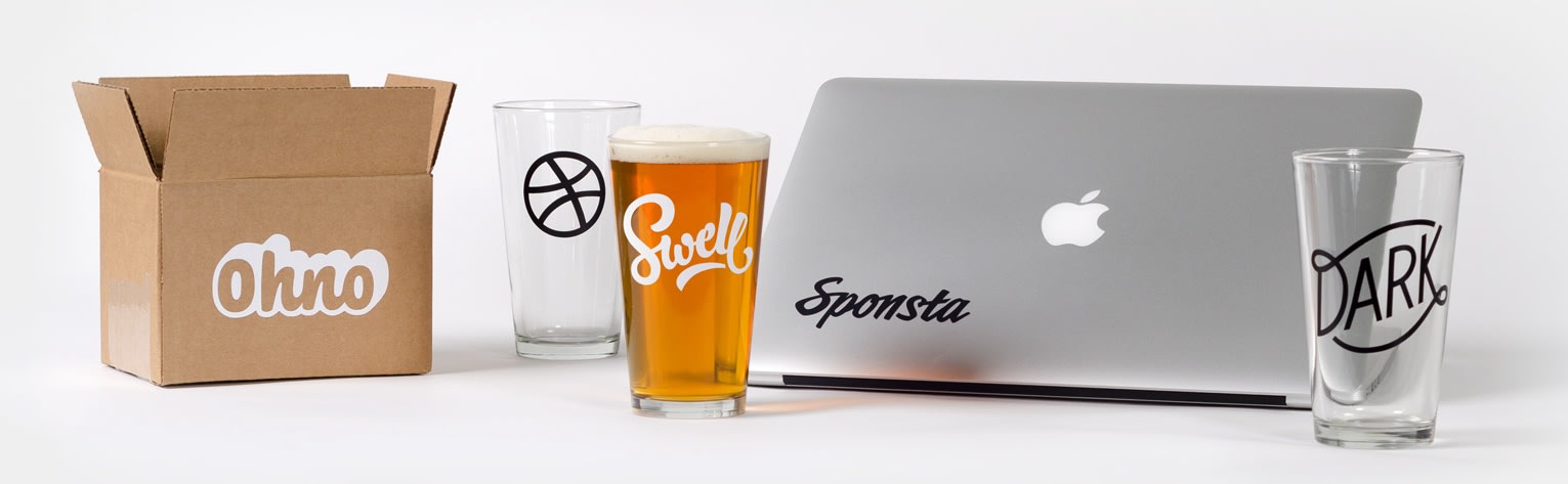shipping box glasses and a laptop computer with custom transfer stickers