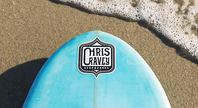 blue surfboard with a custom sticker