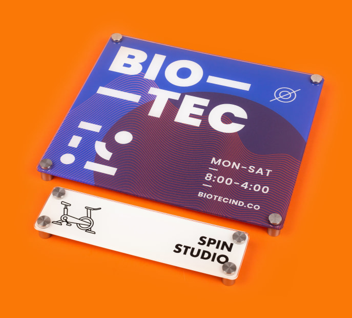a custom printed acrylic sign for a bio tec spin studio on an orange background