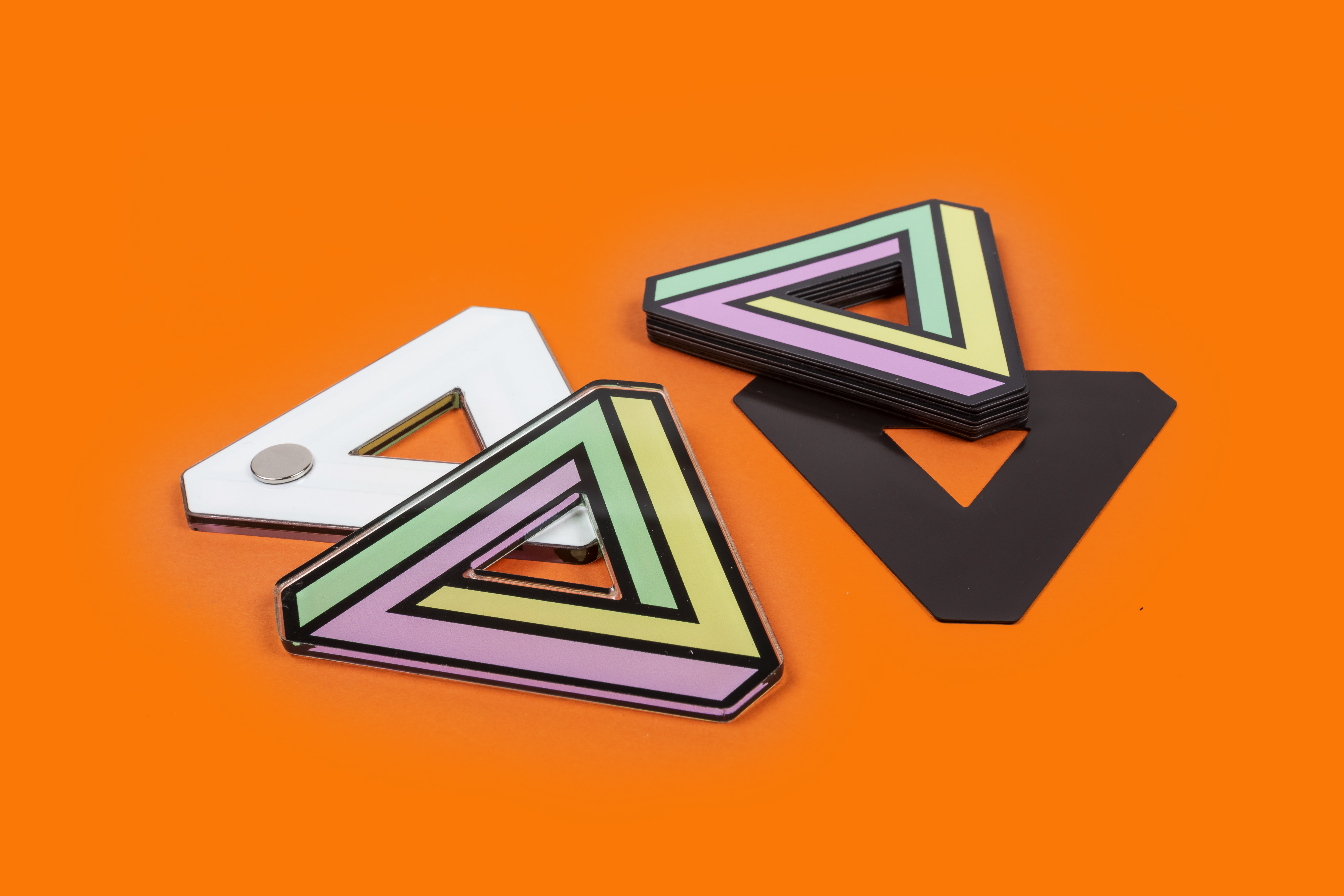 custom acrylic and standard custom magnet cut in a triangular shape with a triangular inner cut
