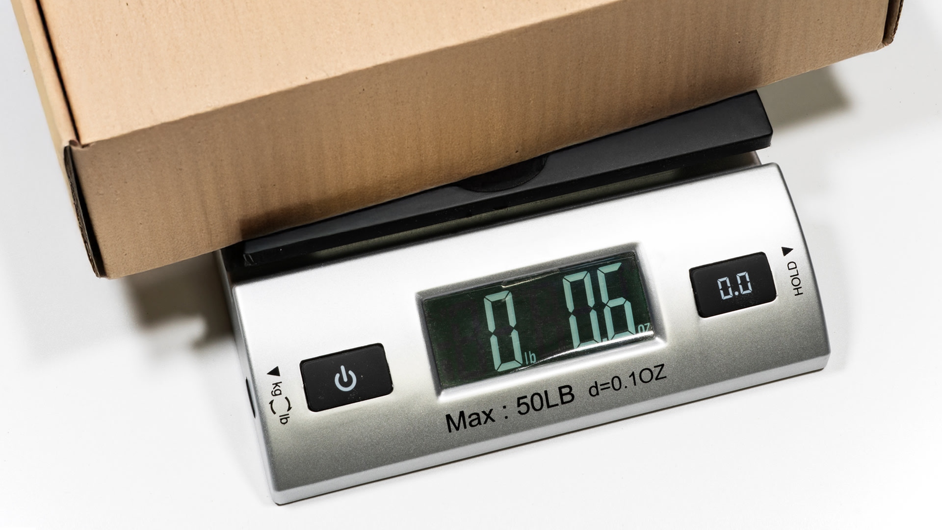 weighing a package on a postal scale