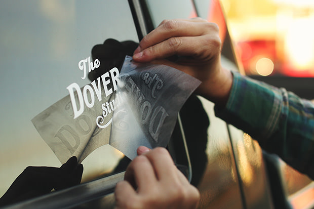 putting on a car decal on the rear windshield